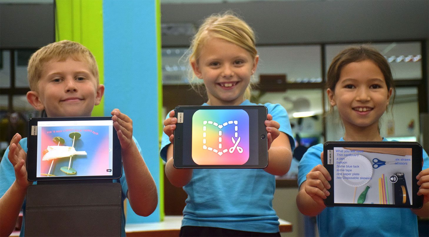 Students holding up their iPads