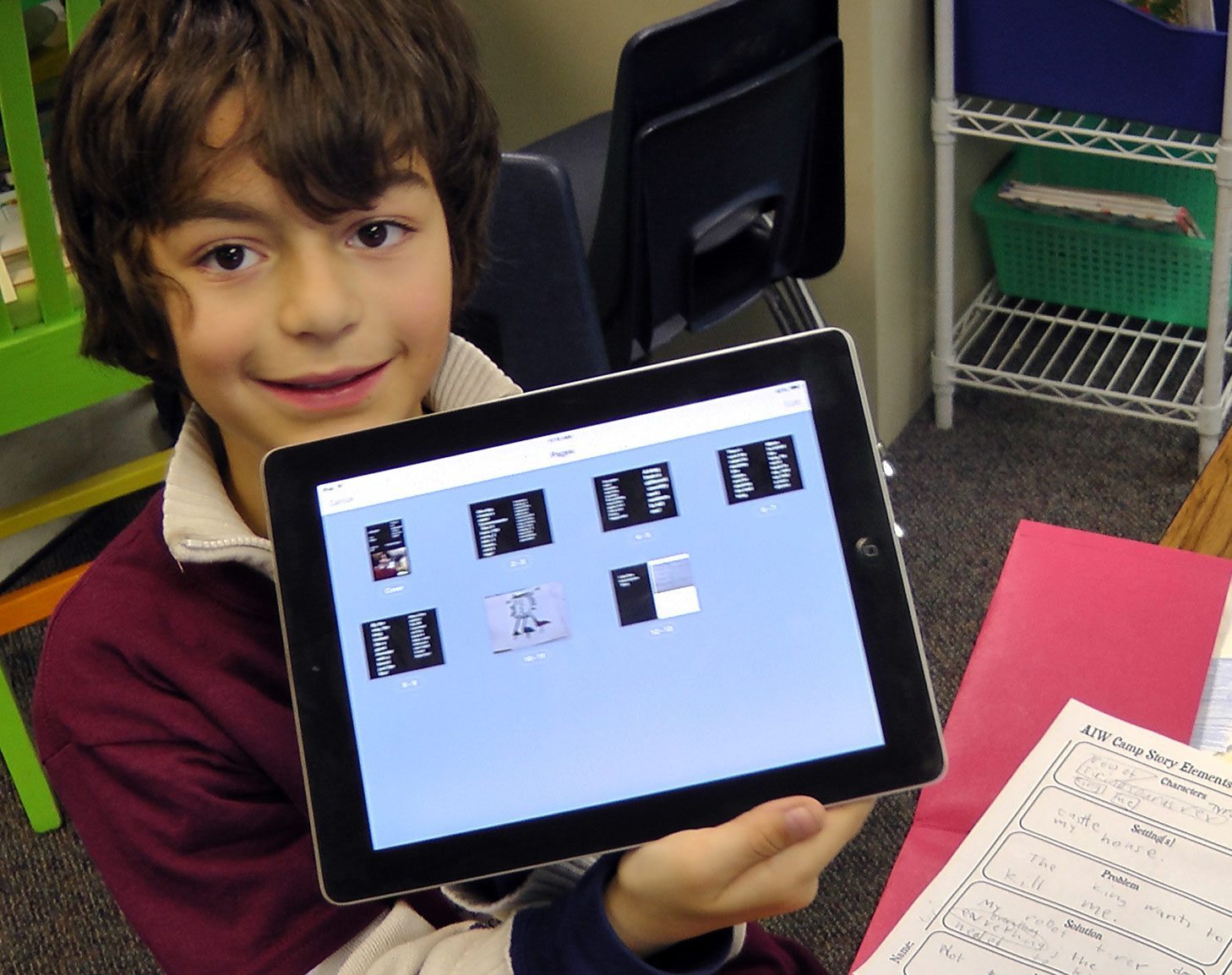 Boy holding iPad at the summer reading camp