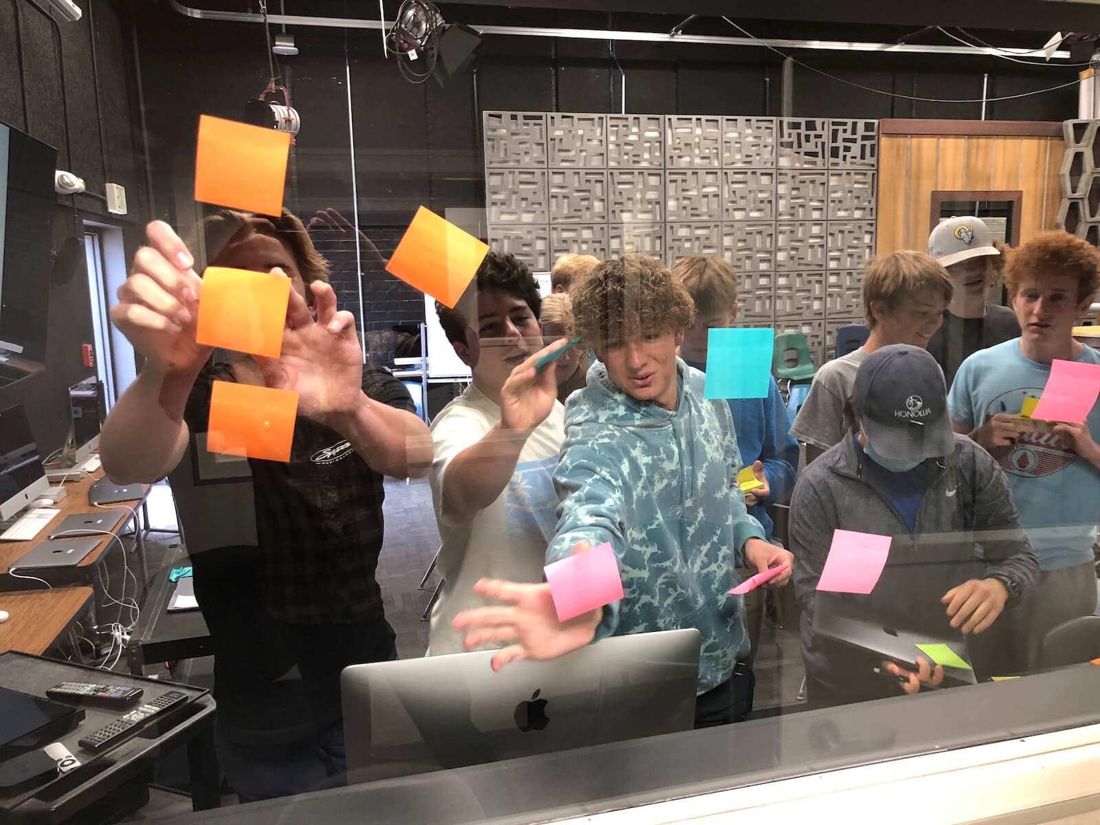 Students using post it notes to brainstorm