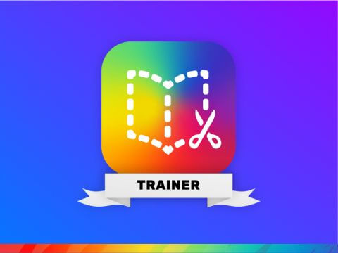 The Book Creator Trainer badge, featuring the Book Creator logo—a colorful square with a dotted book outline and a pair of scissors symbol—on a gradient blue and purple background. The word 'TRAINER' is displayed on a white ribbon at the bottom of the logo.